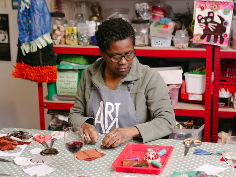 Mother making jewellery at a jewellery class